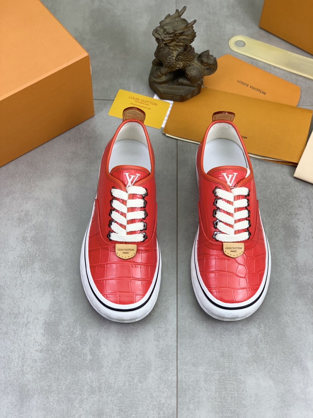 Louis Vuitton Red Embossed Low-Top Sneakers — hero