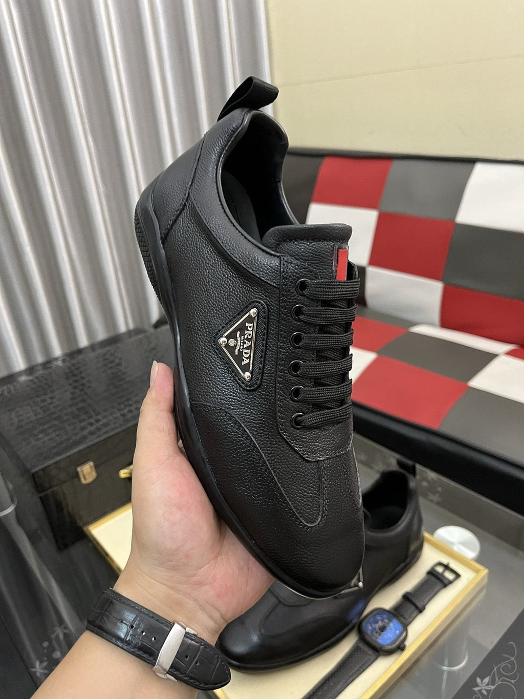Prada Black Lace-Up Sneakers with Red Tab — model