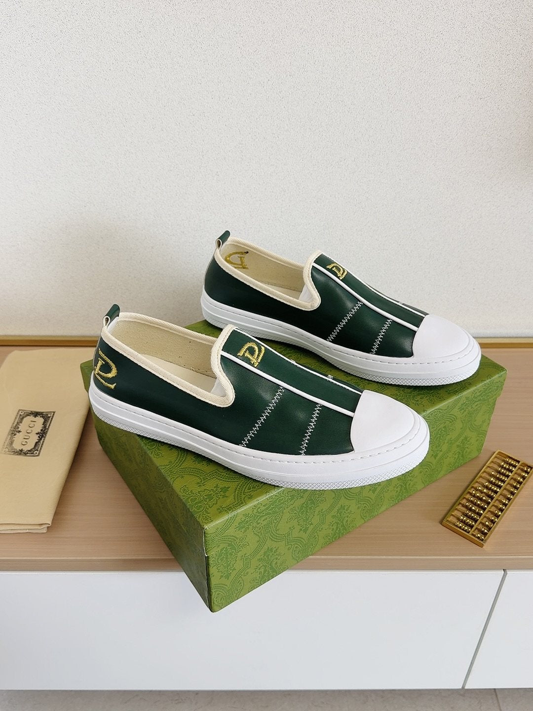 Gucci Brown Slip-On Sneakers with White Toe Caps — front